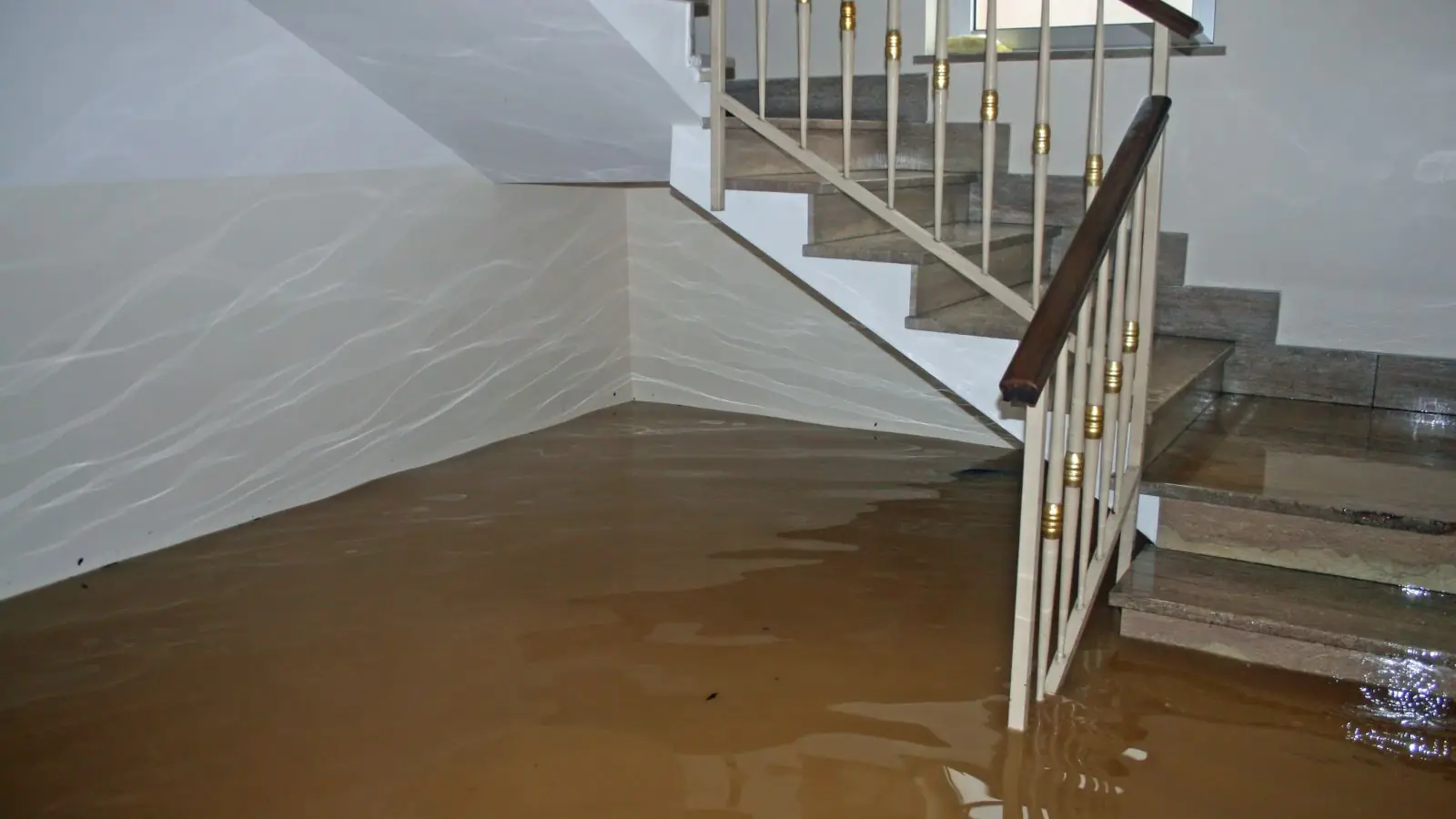 Basement staircase with floodwater covering the lower steps