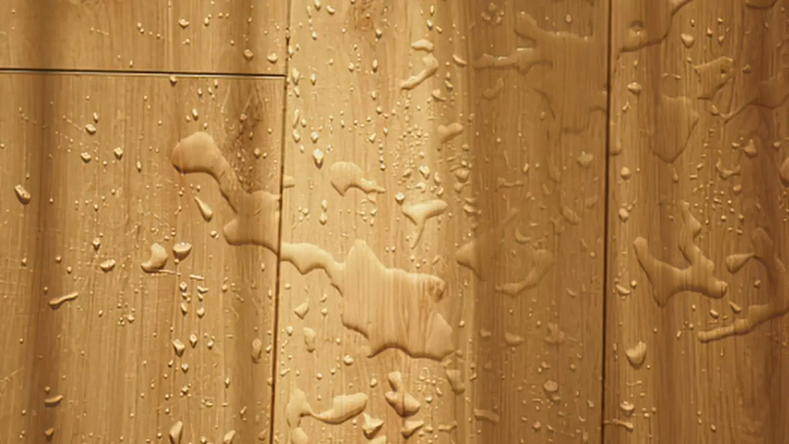 Water droplets standing on a wood plank floor